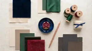 Flat-lay mood board of color swatches and ribbon around a gourmet wedding fouer